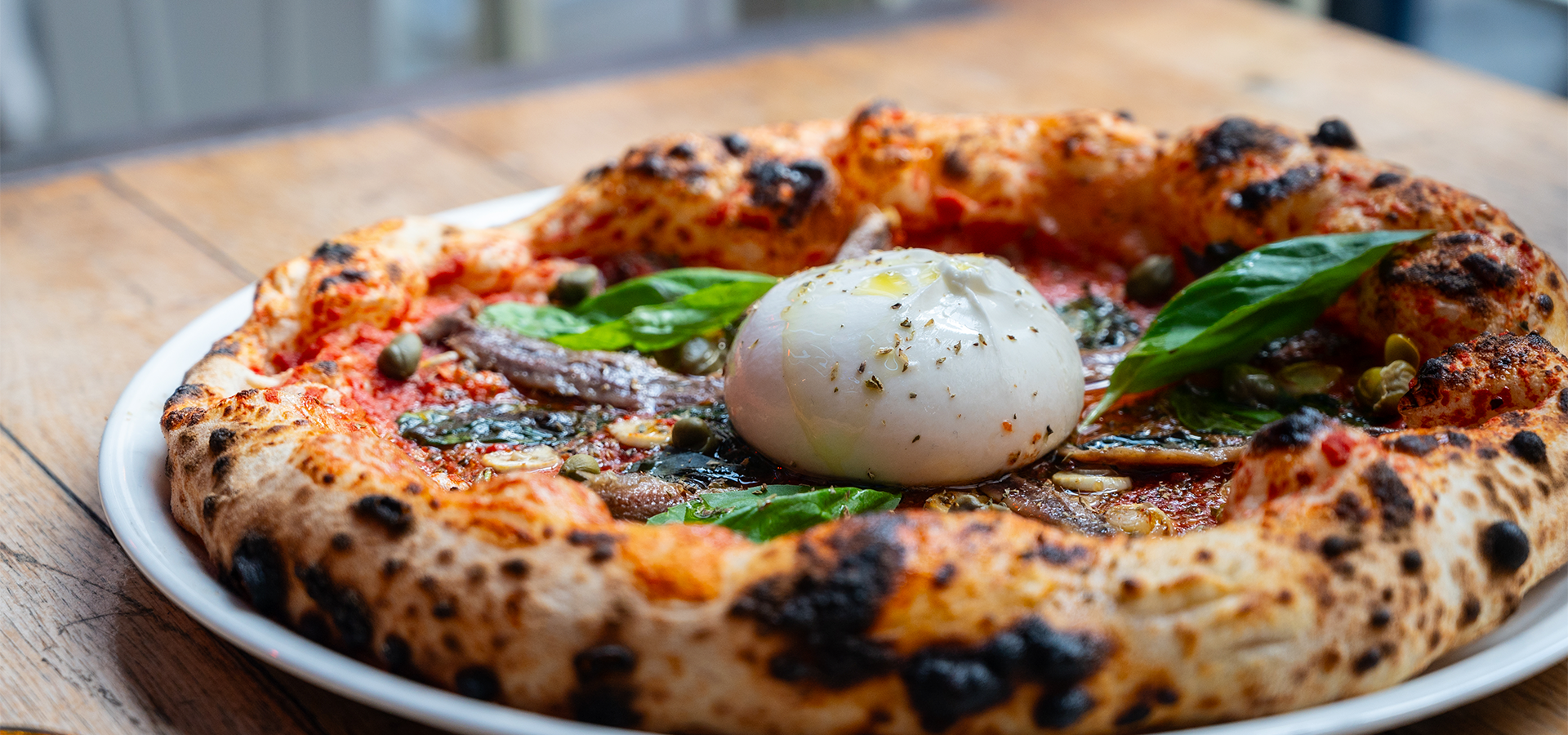A table topped with lots of different types of pizza.